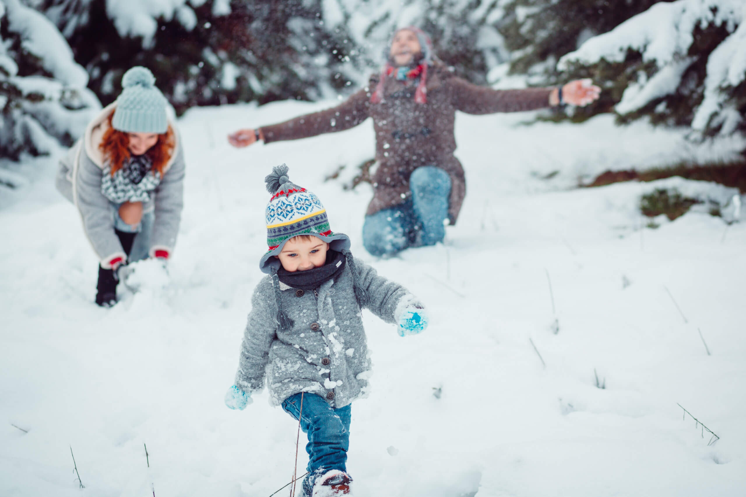 The small child running along snow